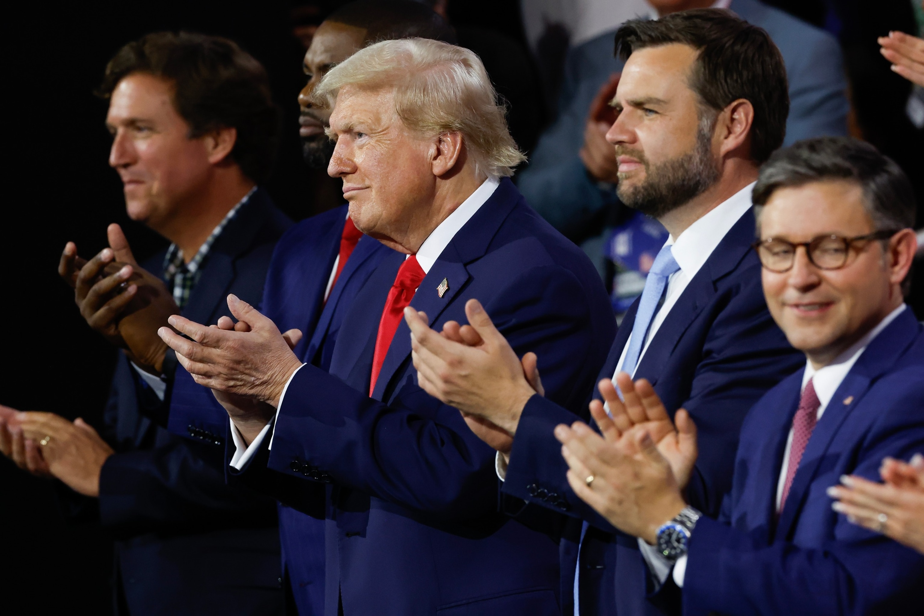 PHOTO: Tucker Carlson, Rep. Byron Donalds, former U.S. President Donald Trump, Sen. J.D. Vance and Speaker of the House Mike Johnson appear at the Republican National Convention, July 15, 2024, in Milwaukee.