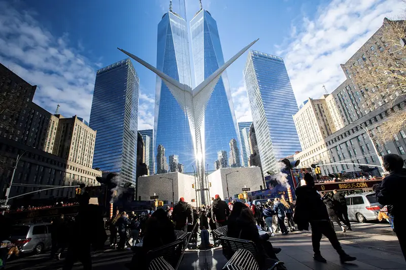 People walk around the Financial District near the New York Stock Exchange (NYSE) in New York, U.S., December 29, 2023. REUTERS/Eduardo Munoz/File Photo