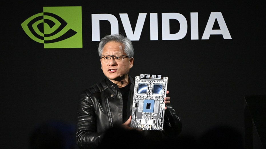 Nvidia CEO Jensen Huang holds chip