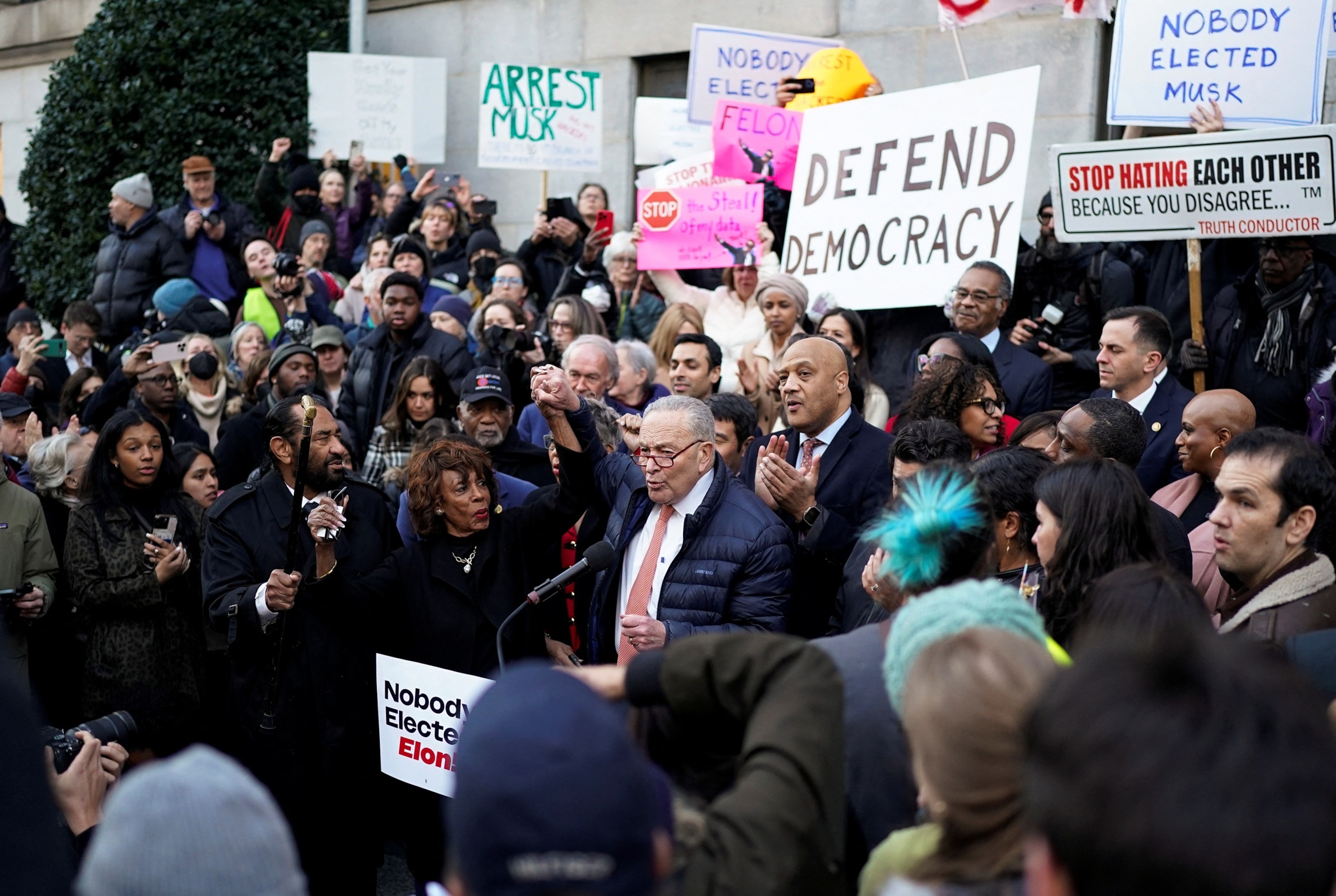 PHOTO: Senate Minority Leader Chuck Schumer (D-NY) speaks as U.S. Representative Maxine Waters (D-CA) stands next to him, while demonstrators rally outside the U.S. Treasury Department, in Washington, Feb. 4, 2025. 