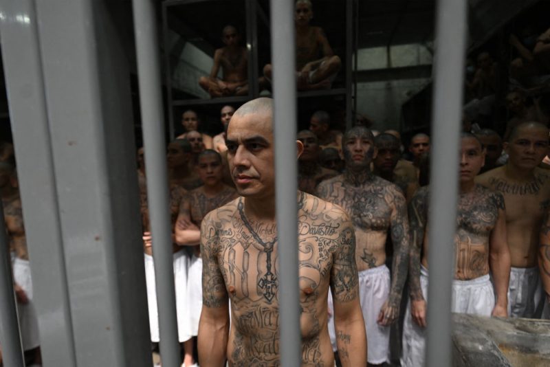 Inmates look on as they remain in a cell at the Counter-Terrorism Confinement Centre (CECOT) mega-prison, where hundreds of members of the MS-13 and 18 Street gangs are being held, in Tecoluca, El Salvador on January 27, 2025. The CECOT, the largest prison in Latin America and emblem of the war against gangs of the government of President Nayib Bukele, celebrates two years since it was inaugurated on February 1. (Photo by Marvin RECINOS / AFP) (Photo by MARVIN RECINOS/AFP via Getty Images)