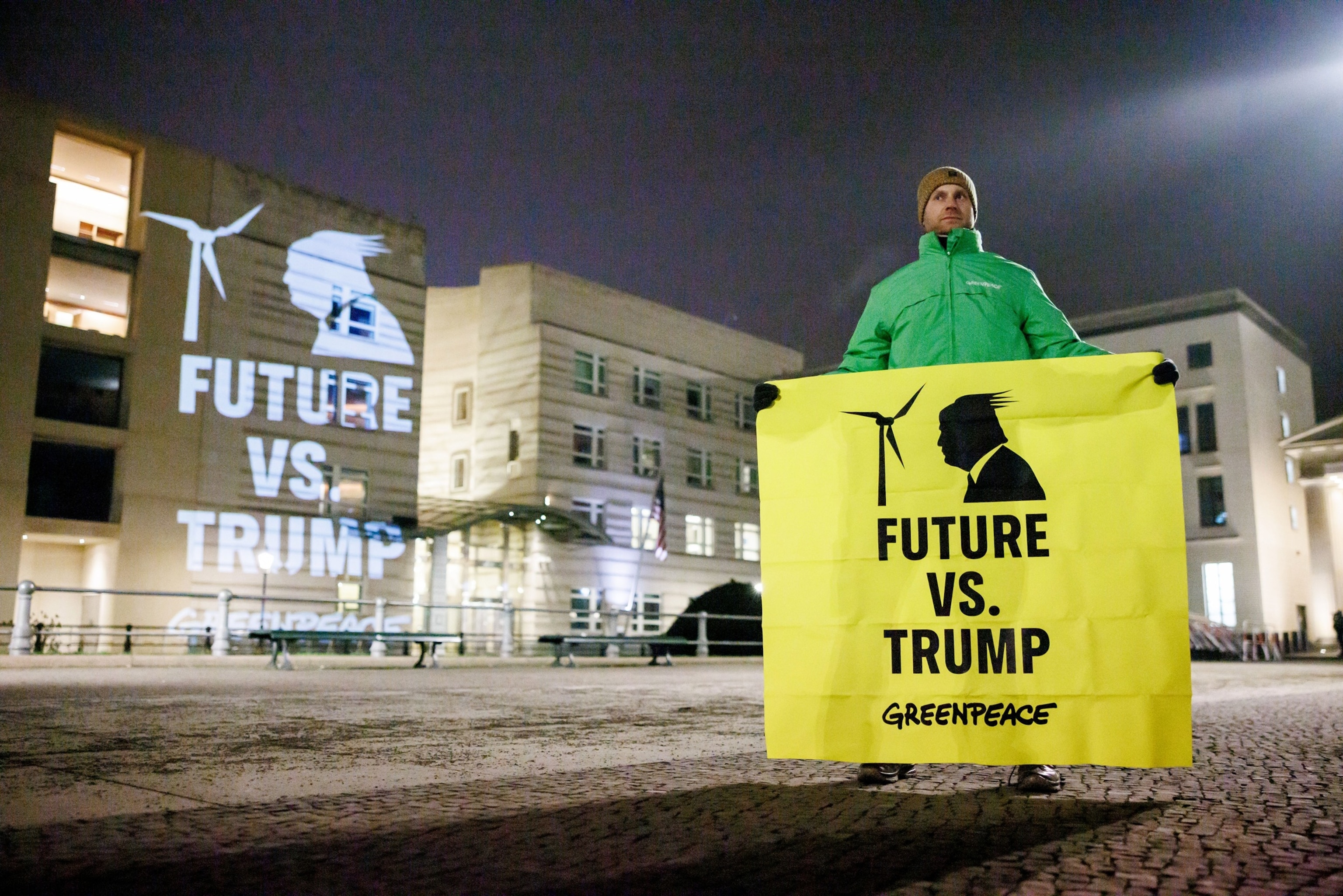 PHOTO: An activist displays a banner reading 'Future vs. Trump - Greenpeace' as he stands at the US embassy in Berlin, Jan. 21, 2025. 