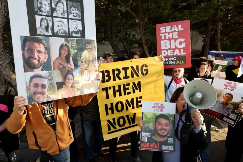 Demonstrators raise placards and chant slogans during a protest calling for the release of hostages held captive in Gaza since the October 7, 2024 attack by Palestinian militants, in front of the residence of the Israeli President in Tel Aviv on February 14, 2025. (Photo by JACK GUEZ / AFP) (Photo by JACK GUEZ/AFP via Getty Images)