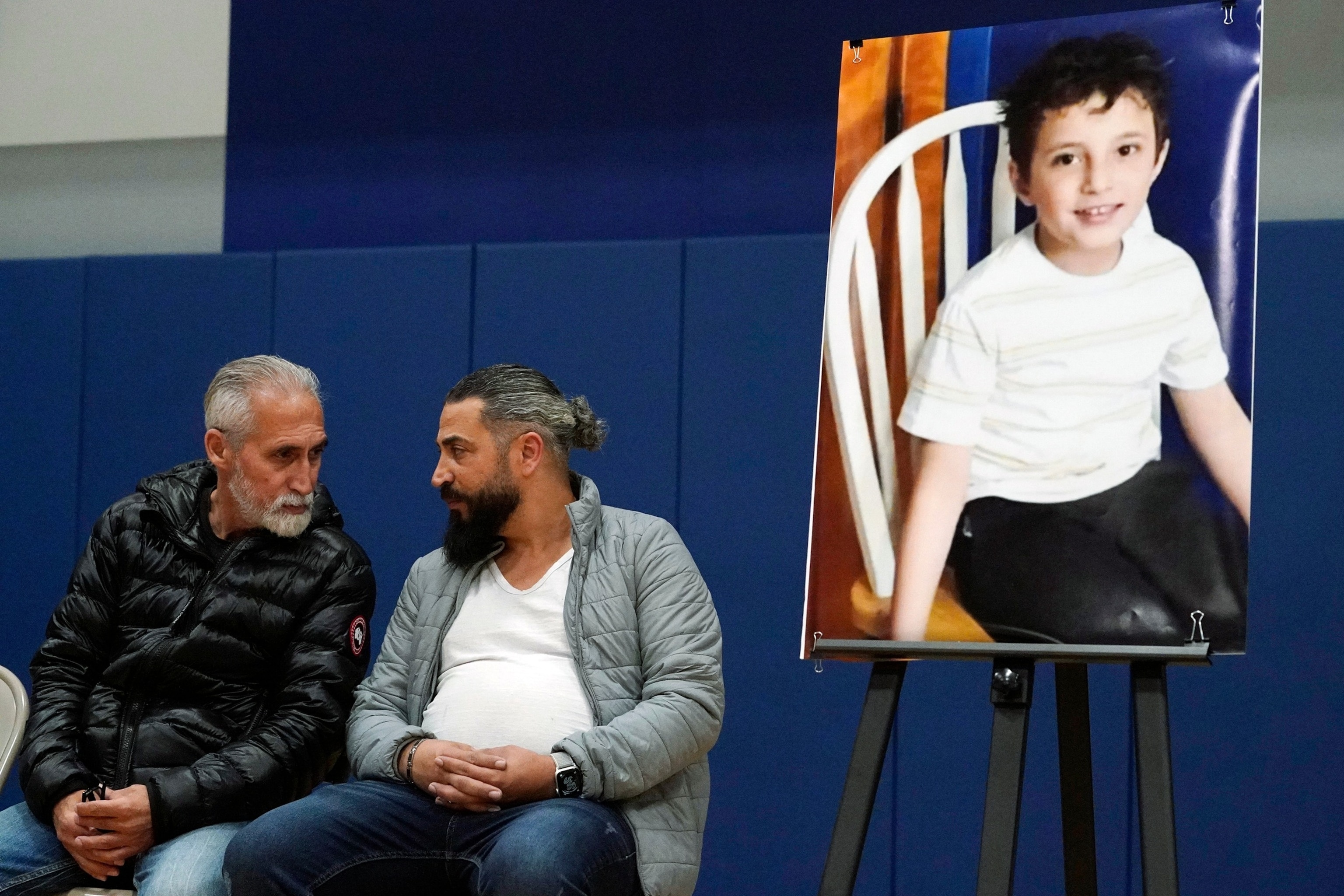 PHOTO: Wadee Alfayoume's father, Oday Al Fayoume, seated right, and his uncle Mahmoud Yousef attend a vigil for Wadee at Prairie Activity and Recreation center in Plainfield, Ill., Oct. 17, 2023. 