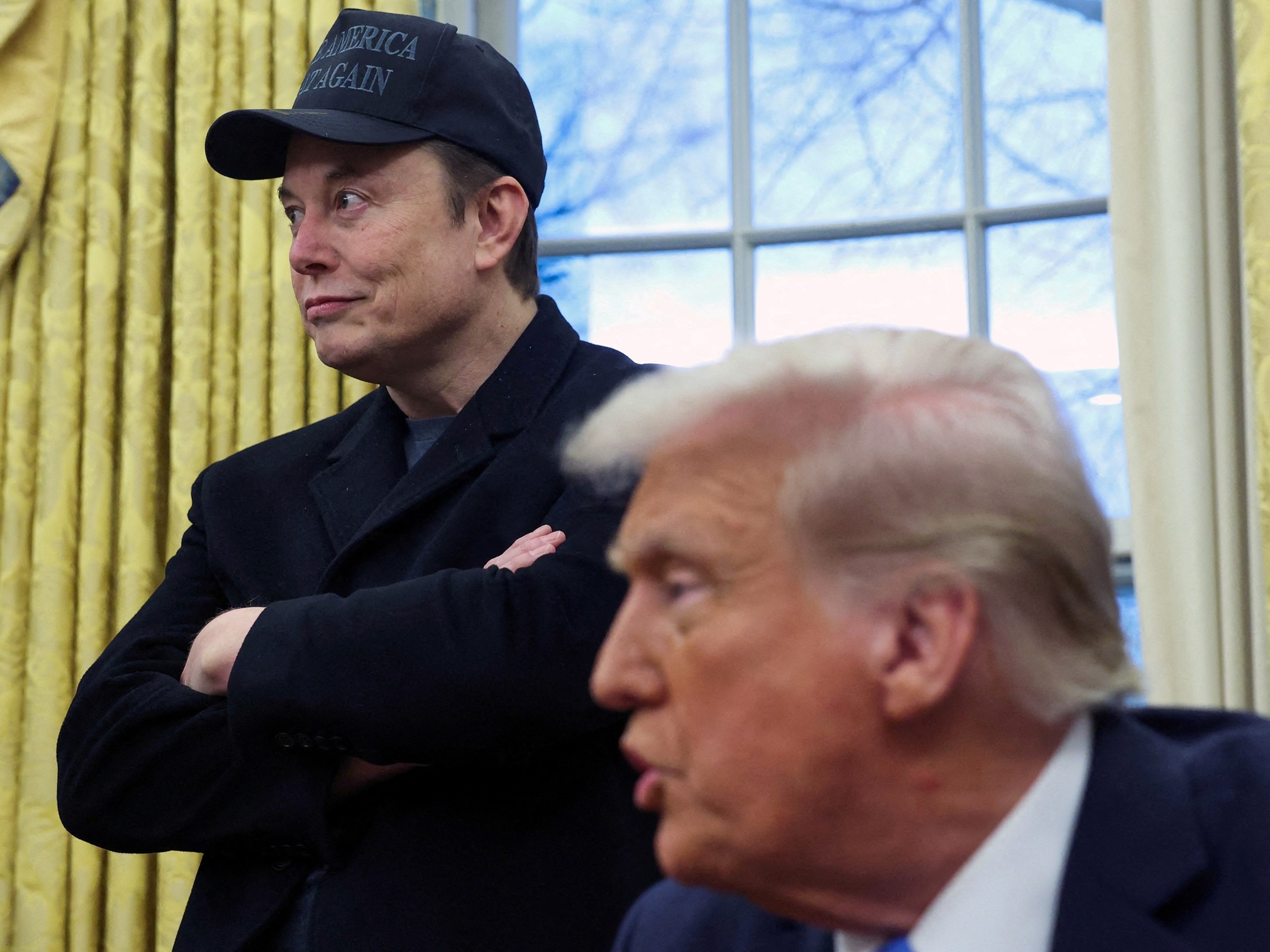 PHOTO: Elon Musk listens to President Donald Trump speak in the Oval Office of the White House in Washington, D.C., Feb. 11, 2025.