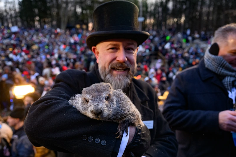 : Groundhog handler AJ Dereume holds Punxsutawney Phil after he saw his shadow predicting 6 more weeks of winter during the 139th annual Groundhog Day festivities on Friday February 2, 2025 in Punxsutawney, Pennsylvania. Groundhog Day is a popular tradition in the United States and Canada. If Punxsutawney Phil sees his shadow he regards it as an omen of six more weeks of bad weather and returns to his den. Early spring arrives if he does not see his shadow, causing Phil to remain above ground. (Photo by Jeff Swensen/Getty Images)