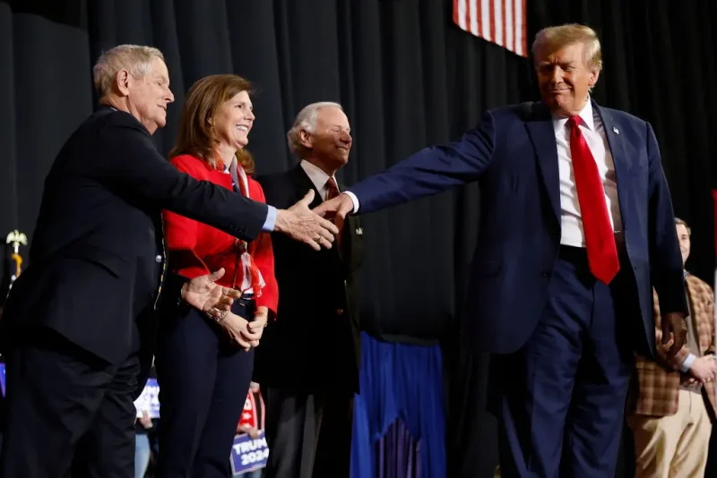 MANCHESTER, NEW HAMPSHIRE - JANUARY 20: Republican presidential candidate and former President Donald Trump (R) shakes hands with Rep. Joe Wilson (R-SC) as a group of South Carolina politicians join Trump on stage during a campaign rally at the SNHU Arena on January 20, 2024 in Manchester, New Hampshire. Trump is rallying four days before New Hampshire voters will weigh in on the Republican nominating race with their first-in-the-nation primary. (Photo by Chip Somodevilla/Getty Images)