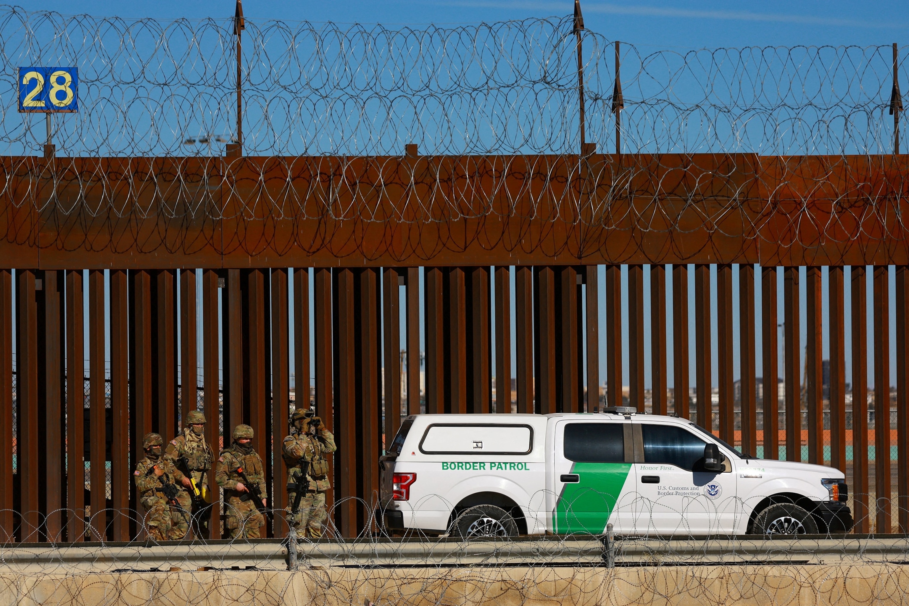 PHOTO: Members of the Texas National Guard stand guard near the border wall between Mexico and the United States, as seen from Ciudad Juarez, Mexico, Jan. 14, 2025. 