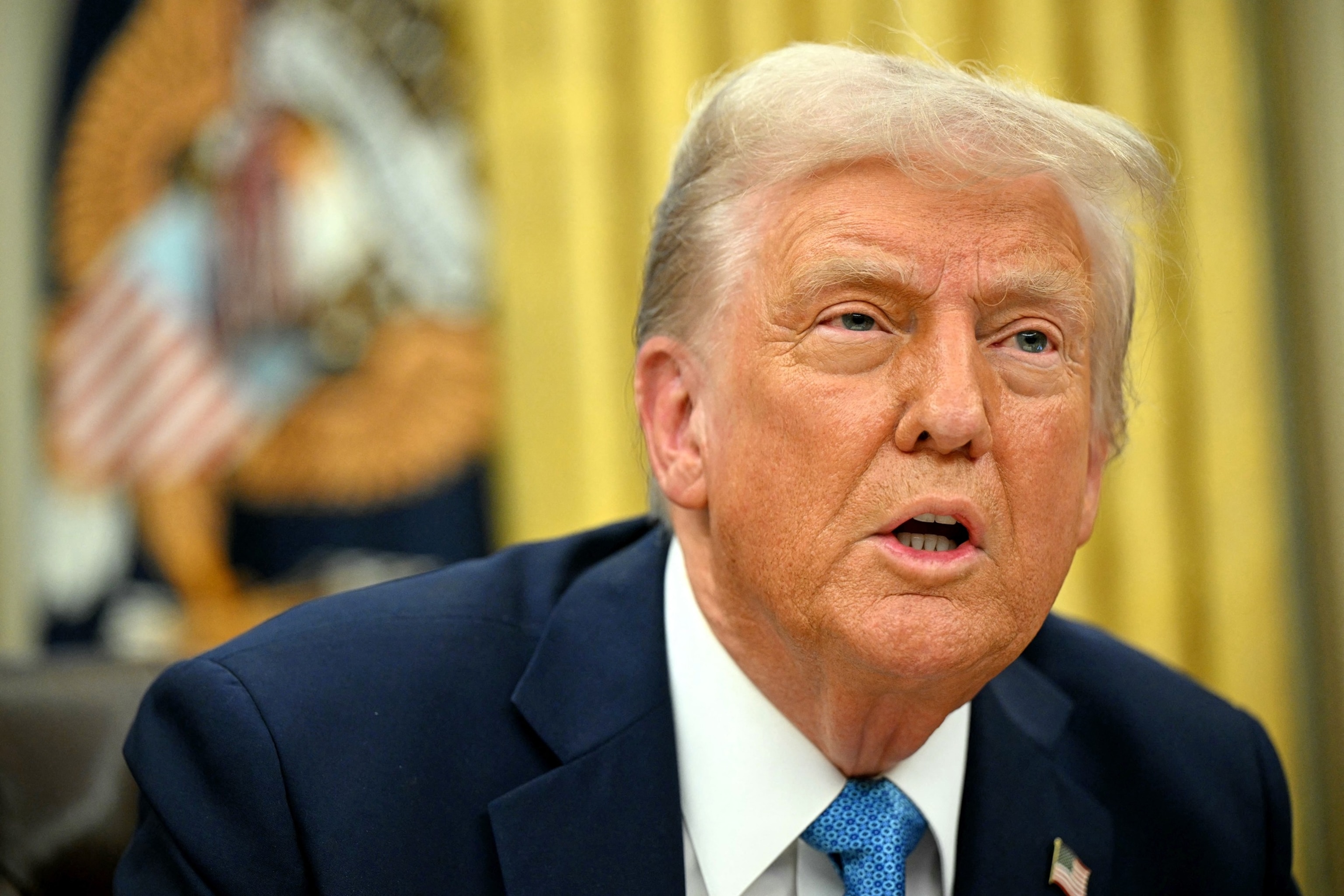 PHOTO: President Donald Trump speaks to the press after after signing an executive order in the Oval Office of the White House in Washington, Jan. 31, 2025.