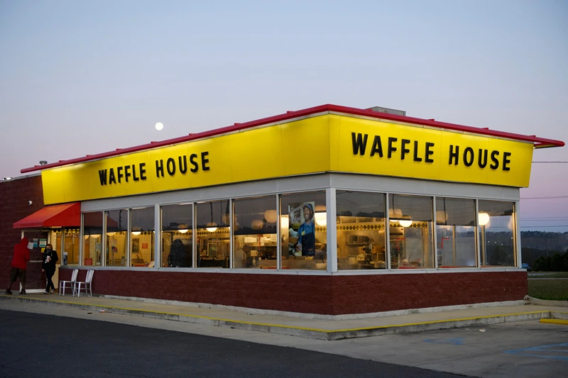 Customers exit a Waffle House restaurant as the moon sets on March 29, 2021 in Bessemer, Alabama. - Votes are set to be counted on March 29, 2021 on whether to create the first Amazon union in the United States, at a warehouse in Alabama, after a historic, five months-long David vs Goliath campaign. "I'm proud of the workers at Amazon for standing up and saying enough," said Joshua Brewer, the local president of the Retail, Wholesale and Department Store Union. (Photo by Patrick T. FALLON / AFP) (Photo by PATRICK T. FALLON/AFP via Getty Images)