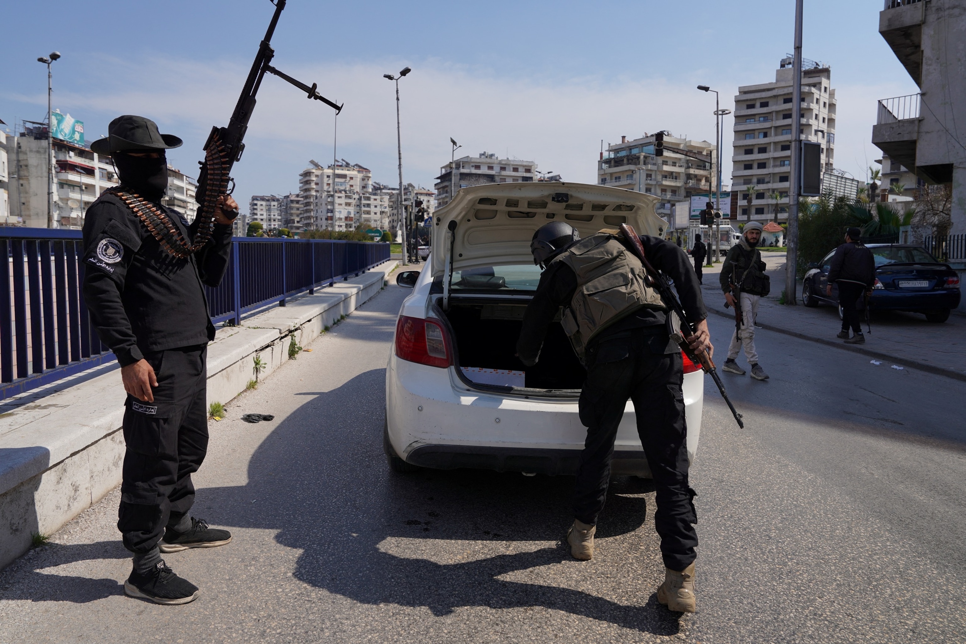 PHOTO: Syrian security forces check a car in Latakia