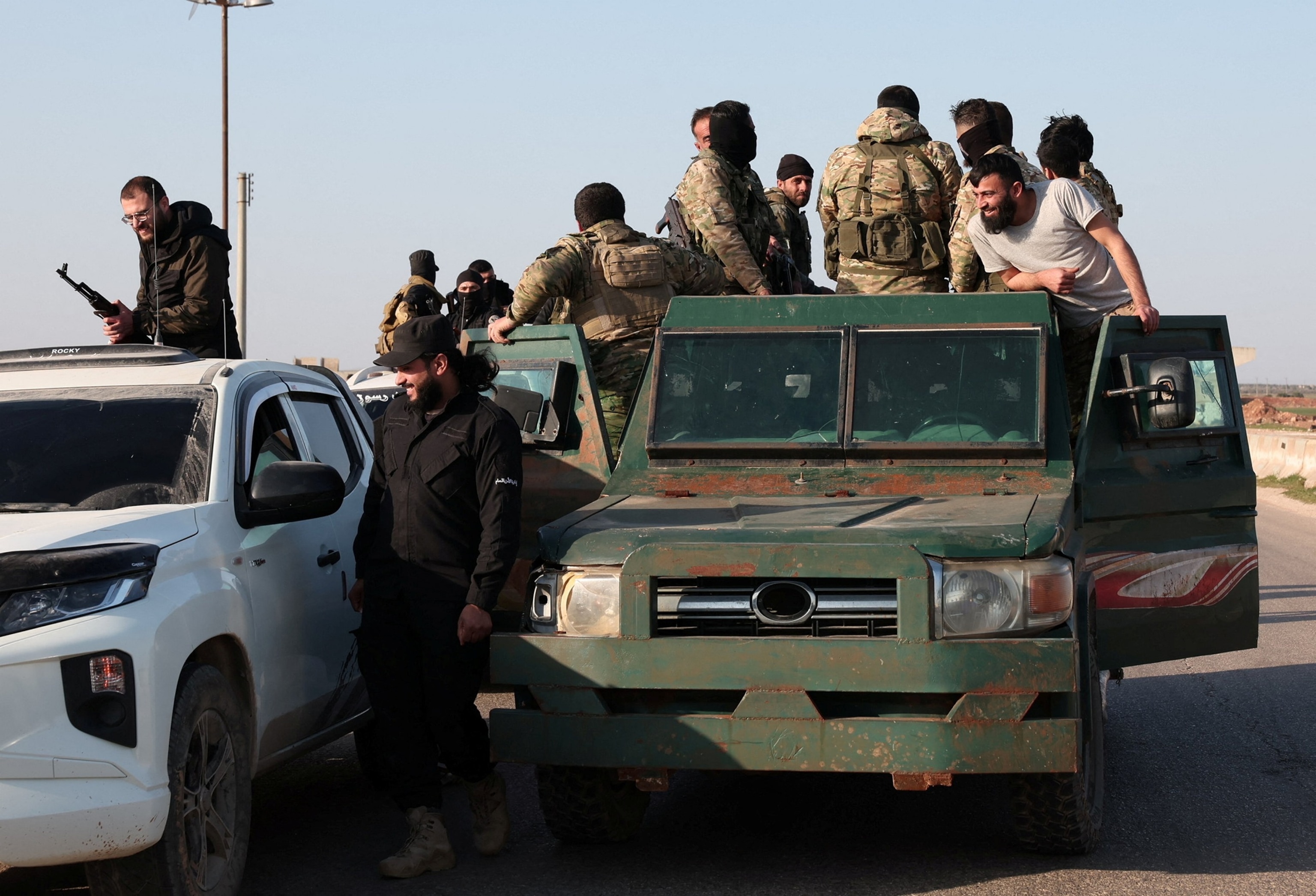 PHOTO: Syrian army personnel gather as they head towards Latakia to join the fight against the fighters linked to Syria's ousted leader Bashar al-Assad, in Aleppo