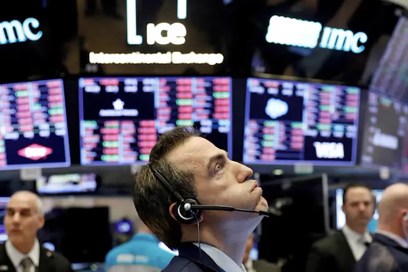 A trader works on the floor of the New York Stock Exchange shortly before the closing bell as the market takes a significant dip in New York, U.S., February 25, 2020. REUTERS/Lucas Jackson/File Photo/File Photo